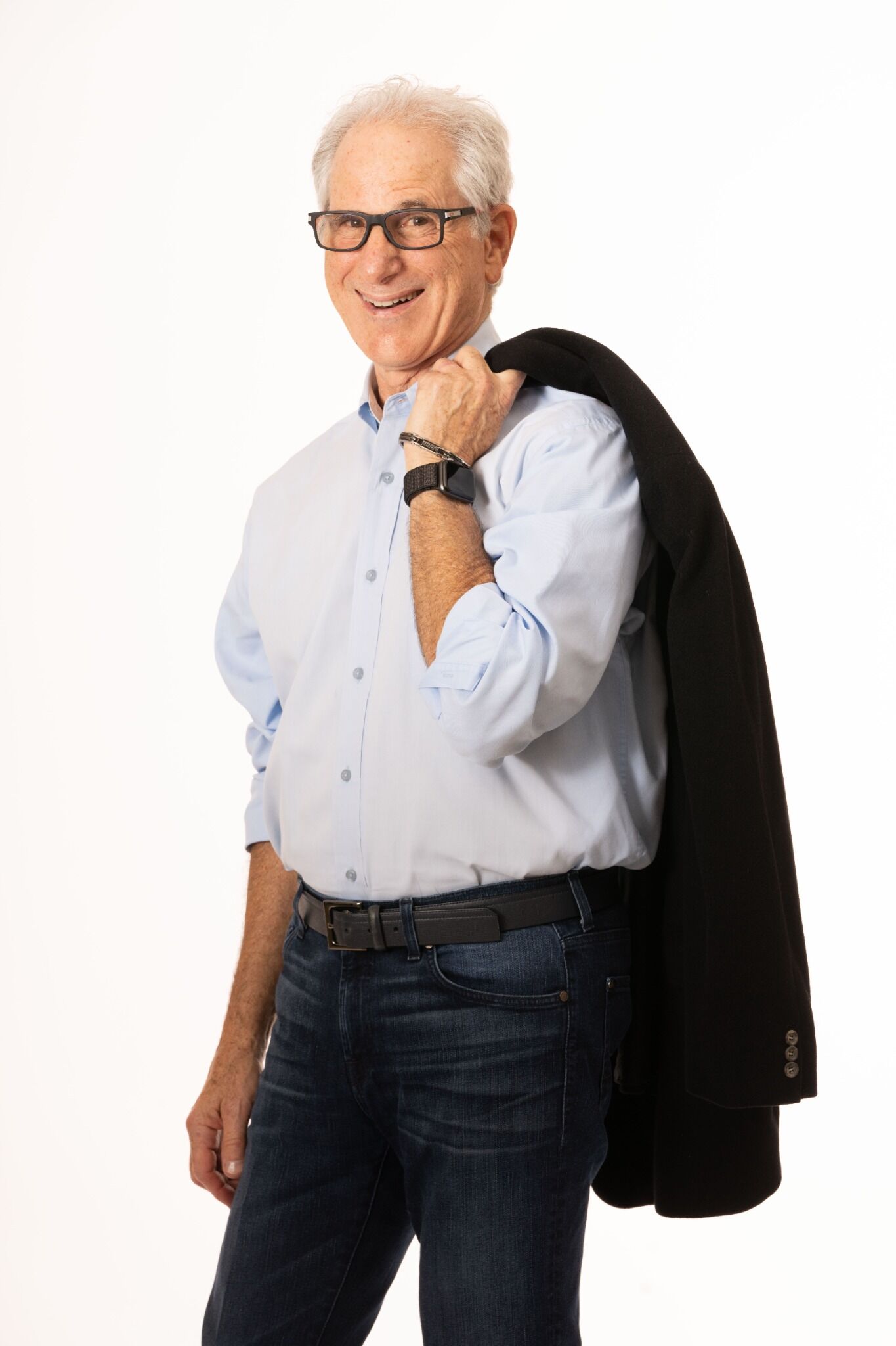 DW Starr smiling with a sport coat over his shoulder